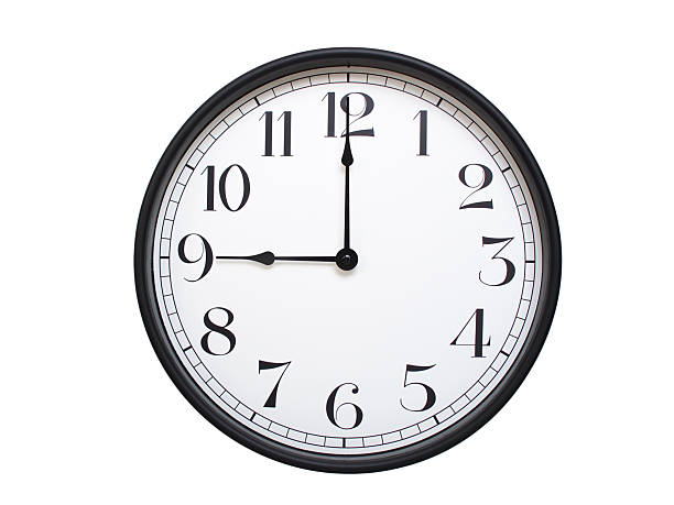 istock Round analog wall clock with a black frame, white face, and bold black numerals. showing  09:00 or 21:00. Isolated on a white background. Ideal for time-related themes. 2224577384