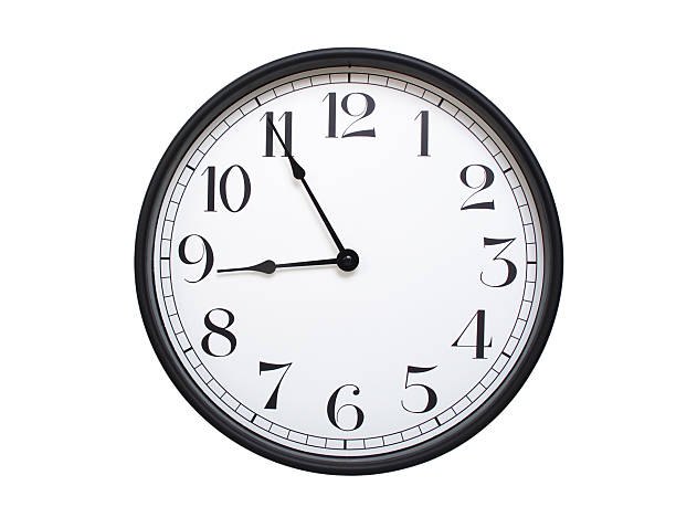 istock Round analog wall clock with a black frame, white face, and bold black numerals. showing  08:55 or 20:55. Isolated on a white background. Ideal for time-related themes. 2224577387