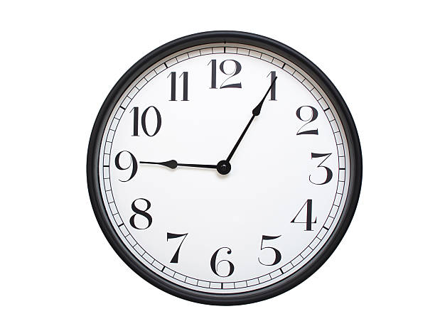 istock Round analog wall clock with a black frame, white face, and bold black numerals. showing  09:05 or 21:05. Isolated on a white background. Ideal for time-related themes. 2224577389