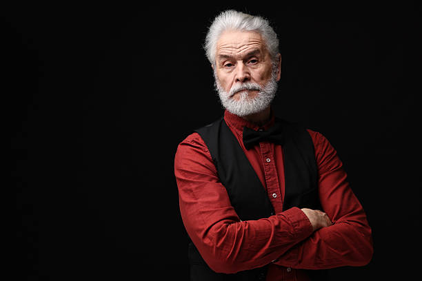 istock Senior man with mustache on black background, space for text 2224578398