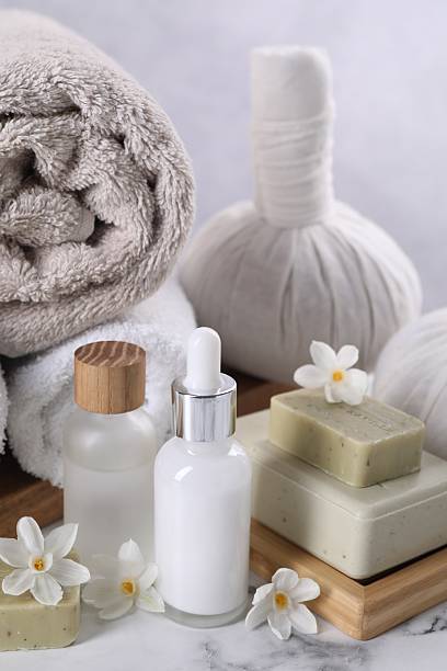 Composition with spa supplies and flowers on white marble table