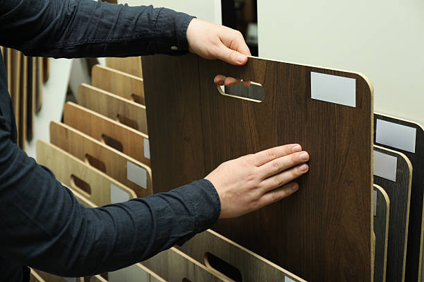 istock Man choosing wooden flooring among different samples in shop, closeup 2224579007
