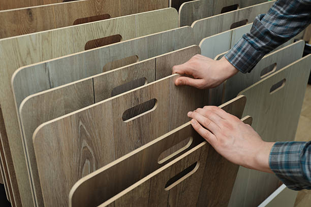 istock Man choosing wooden flooring among different samples in shop, closeup 2224579029