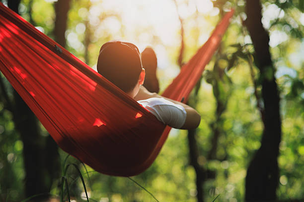 Relaxing in hammock in tropical forest