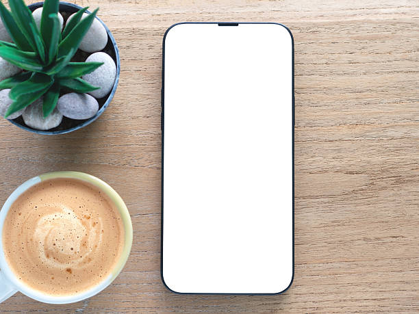 istock A minimalist flat-lay composition featuring a modern smartphone with a blank white screen over a wooden background. Concept online shopping, blog, logo, product, and social media. 2224581228