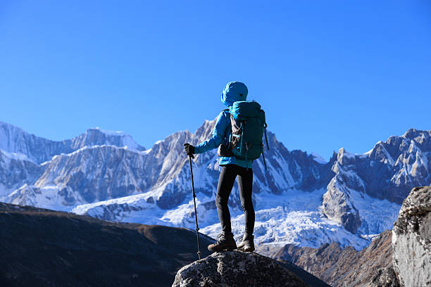 istock Backpacking woman hiking on high altitude mountain top 2224582119