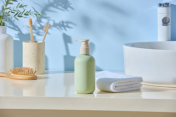 istock Ceramic bottles, toothbrushes and sponge arranged with folded towel in soft blue light. Japandi mood meets wellness lifestyle with open space for design or gentle product mockup. 2224582973
