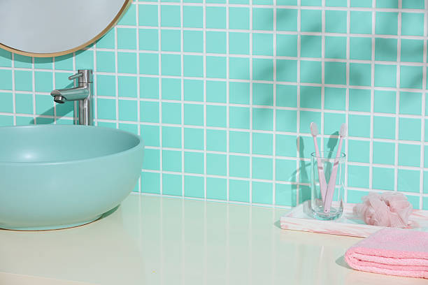 istock A mint ceramic sink, toothbrushes and minimal decor sit below soft shadows on a green tiled wall. Clean Japandi influence with space for simple product visuals or text overlay. 2224583005
