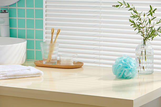 istock Fresh mint-tiled bathroom with a modern sink, folded towels, brush set and bath puff. Clean surface area is left blank for inserting design elements or cosmetic mockups. 2224583071