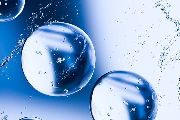 istock 3D render of transparent water bubbles with splashes on a blue background. Abstract hydration and skincare concept representing purity, moisture, and freshness in beauty and cosmetic design. 2224585352