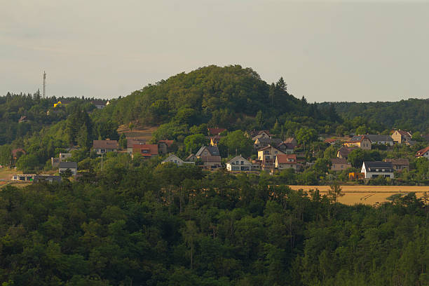 istock A quaint village is atop a hill surrounded by lush trees 2224586403