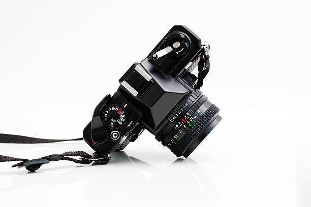 Vintage analog photo camera with lens – side view isolated on white background stock photo