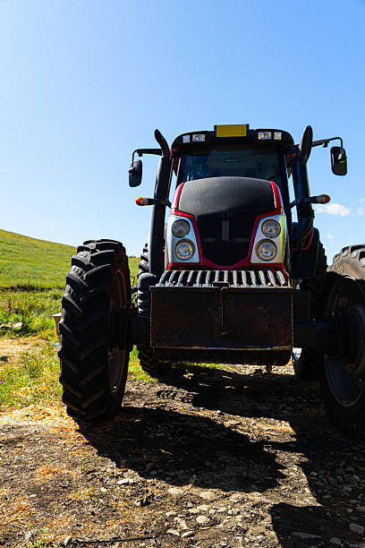 istock Agricultural Tractor Front View on Dirt Road 2224591895