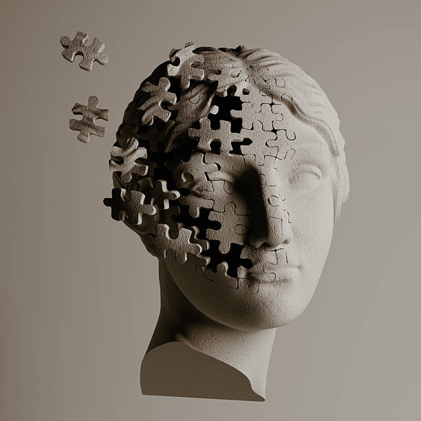 istock Surreal 3D illustration of a classical statue dissolving into puzzle pieces. Metaphor for mental health, dementia, memory loss, anxiety, or a fragmented personality. 2224594021