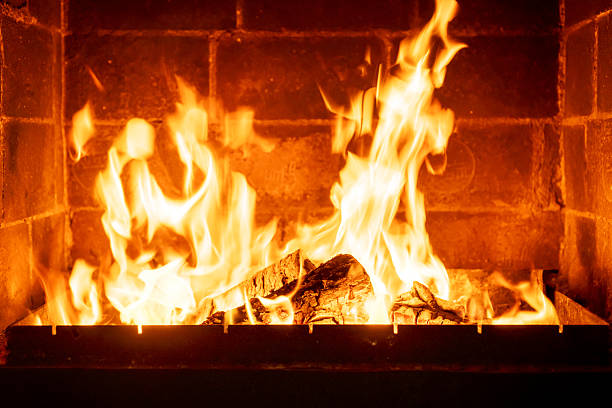 istock Wood logs burning in indoor fireplace, orange-yellow fire creating cozy warm feeling, rustic charm, countryside atmosphere, romantic winter night scene, peaceful comfort concept 2224594114