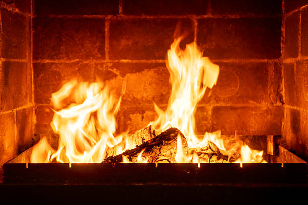 istock Wood logs burning in indoor fireplace, orange-yellow fire creating cozy warm feeling, rustic charm, countryside atmosphere, romantic winter night scene, peaceful comfort concept 2224594116