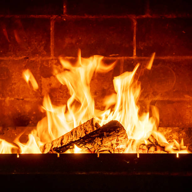 istock Interior fireplace glowing with fire, bright flames above stacked logs, cabin-like atmosphere, warmth concept, natural wood burning indoors 2224594128