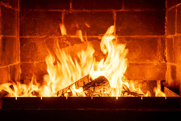 istock Burning fireplace logs with high flames inside brick hearth, cozy interior warmth, traditional home heating, rustic ambiance, romantic cabin atmosphere, winter season comfort, firewood crackling sound 2224594424