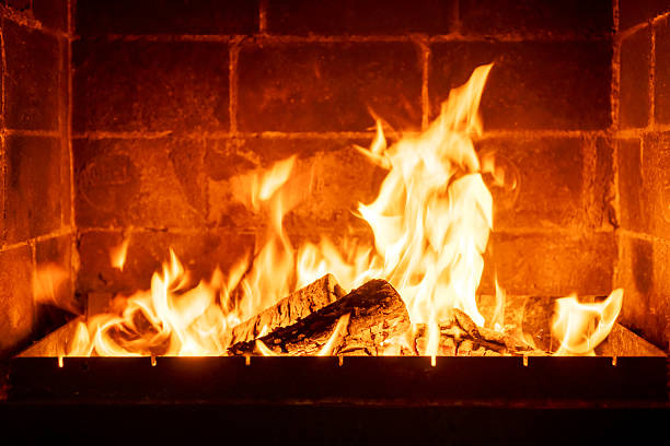 istock Bright fireplace flame consuming wooden logs, rustic warmth, glowing ambiance, interior brick wall, cozy home feeling, winter evening heat, traditional heating symbol, peaceful indoor mood 2224594432