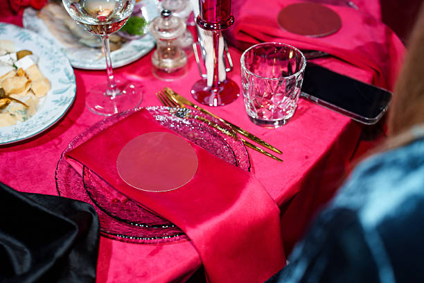 istock Setting a festive table with a red tablecloth and napkins with a name card. 2224594493