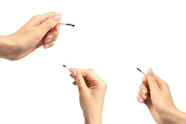 istock Lit match in a woman hand isolated on a white background. 2224594704
