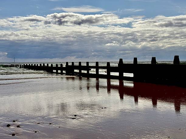 istock Cloudscape over groyne on the beach at Blyth in Northumberland 2224595437