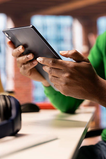 istock Relaxed man at home watching TV show on tablet, close up 2224595531