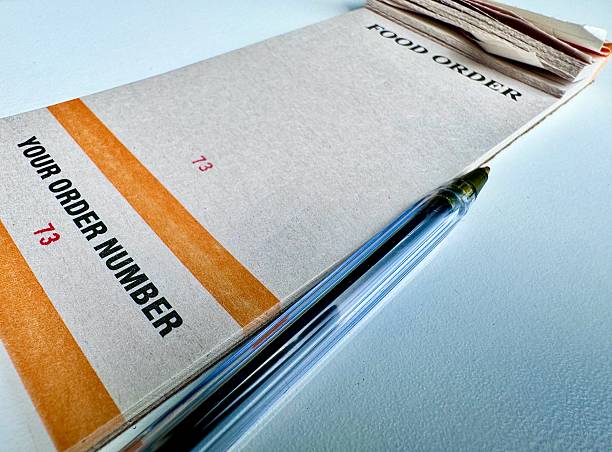 istock A blank food and drink order ticket book with a biro 2224596589
