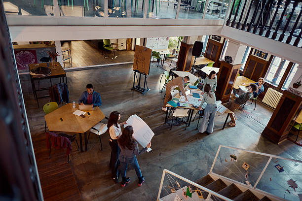 istock Above view of creative people working in a modern coworking space. 2224597926