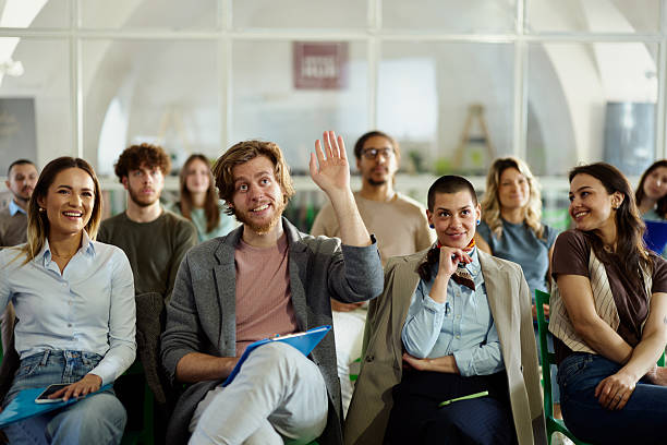 istock Happy creative man has a question on a seminar in board room. 2224599372
