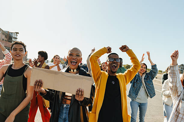 istock Young diverse adults protesting outdoors for unity and positive social change 2224601356