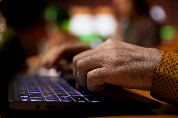 istock Focused mature student reading educational papers in a university library 2224602352