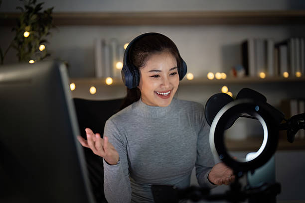 istock Podcast host expressing excitement while recording in a vibrant studio 2224602744