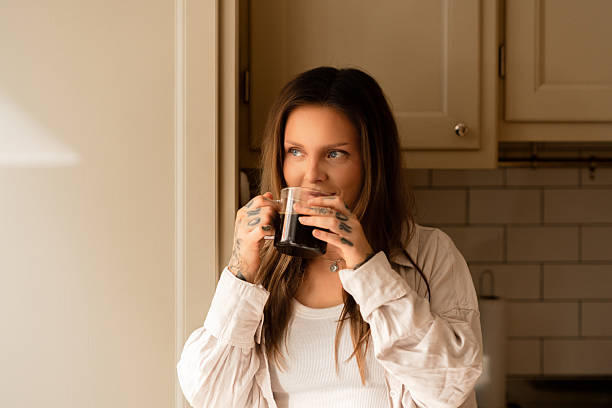istock Woman drinking coffee while relaxing in a warm and cozy kitchen setting 2224604381