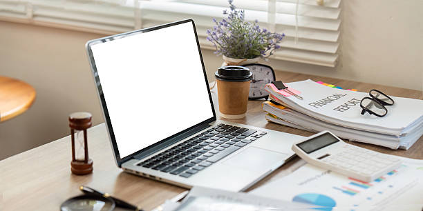 istock Workspace and Productivity. Laptop and financial documents on a desk with coffee. 2224604540