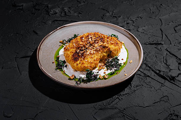 istock Deliciously plated cauliflower steak with nut garnish and sauce 2224605510