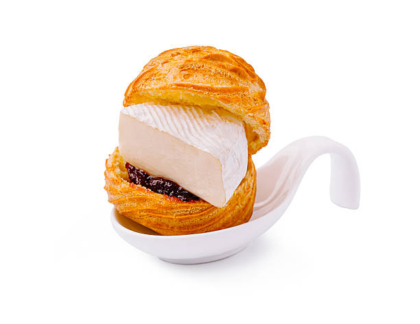 istock Delicious pastry filled with cream and fruit preserves served on a spoon 2224605535