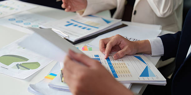 istock Data Analysis and Reporting. Close-up of hands reviewing business charts and graphs. 2224605683