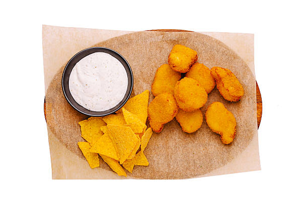 istock Delicious fried snacks served with dipping sauce on a wooden platter 2224606919