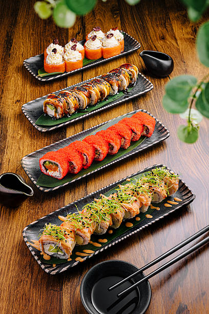 istock Artfully arranged sushi rolls on wooden table in Japanese restaurant setting 2224606944