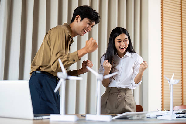 istock Joyful Teamwork. Colleagues celebrating a successful project outcome in a modern office setting. 2224606981