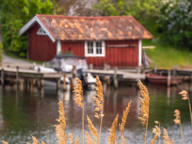 istock Tranquil Red Boathouse by the Water 2224607564
