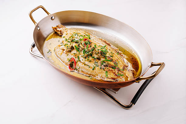 istock Deliciously cooked whole fish garnished with fresh herbs and spices 2224608388