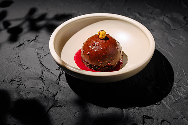 istock Decadent chocolate dessert served on a unique dish with berry sauce 2224608472