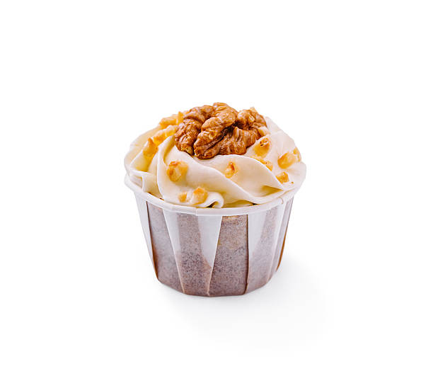 A single cupcake showcases fluffy frosting and a generous walnut on top. Set against a plain background, this treat looks inviting and perfect for dessert lovers at any event.