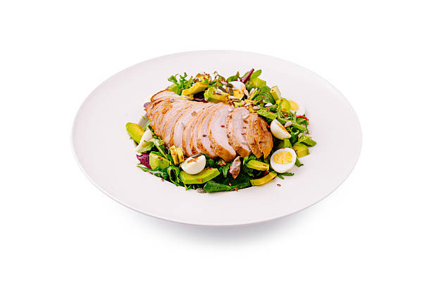 istock Delicious salad with sliced chicken and mixed greens served on a white plate 2224608534