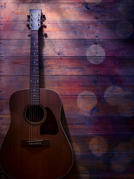 istock Acoustic guitar on a wooden background with bokeh light and space for copy 2224608885