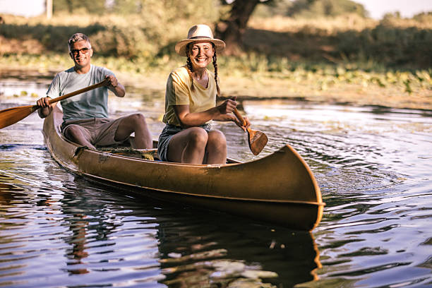 istock happy couple canoeing together on a paceful river at sunset 2224611767