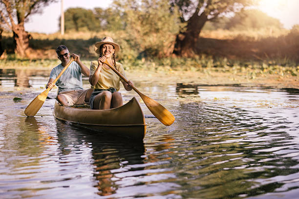 istock happy couple canoeing together on a paceful river at sunset 2224611777