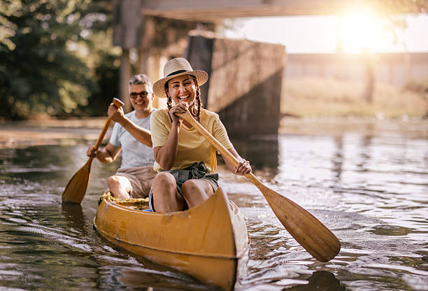 istock happy couple canoeing together on a paceful river at sunset 2224611804